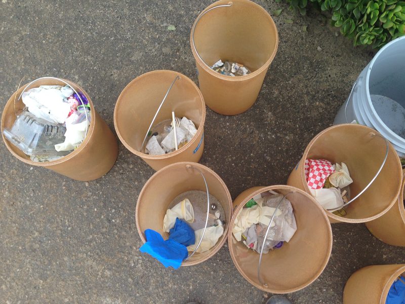 Buckets filled with sorted litter collected on a beach